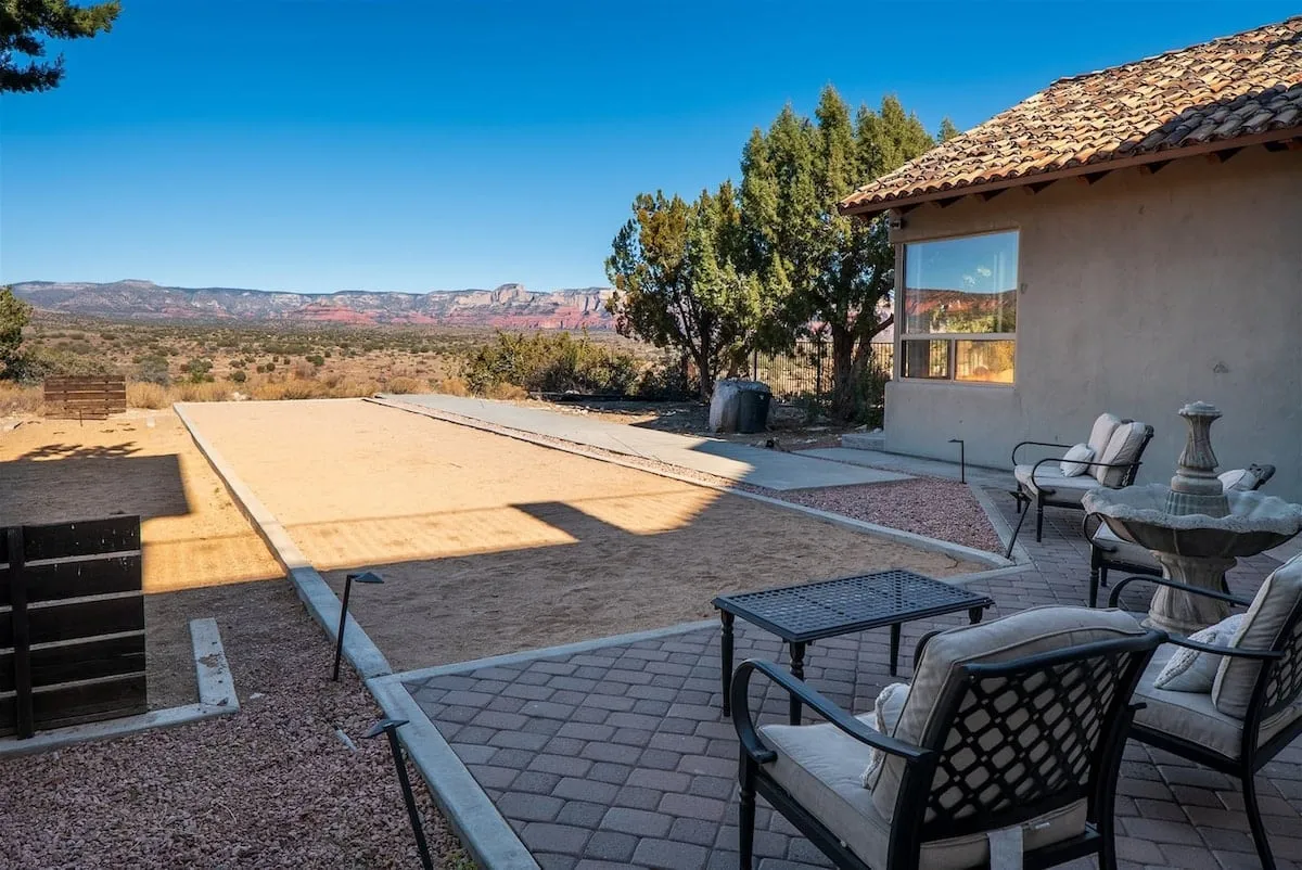 A relaxed bocce ball court stretches alongside a desert landscape, with an inviting outdoor seating area and scenic views. The setup feels social and fun, perfect for enjoying group games or evening gatherings.