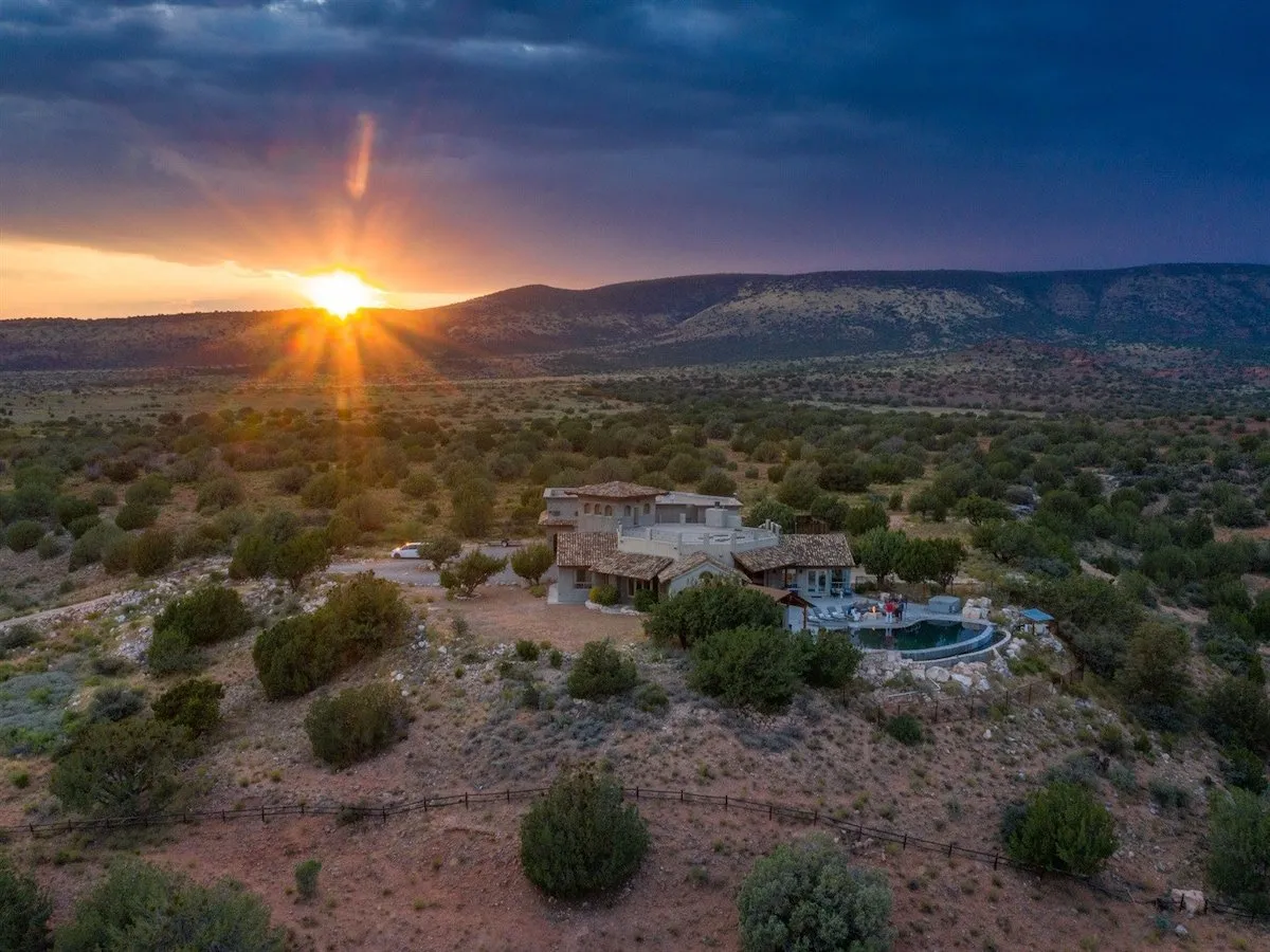 This serene exterior shot shows the house and pool at sunset, surrounded by natural beauty. It hints at evening gatherings, reflection, and the magic of sharing stories as the sun sets over Sedona’s Red Rocks.